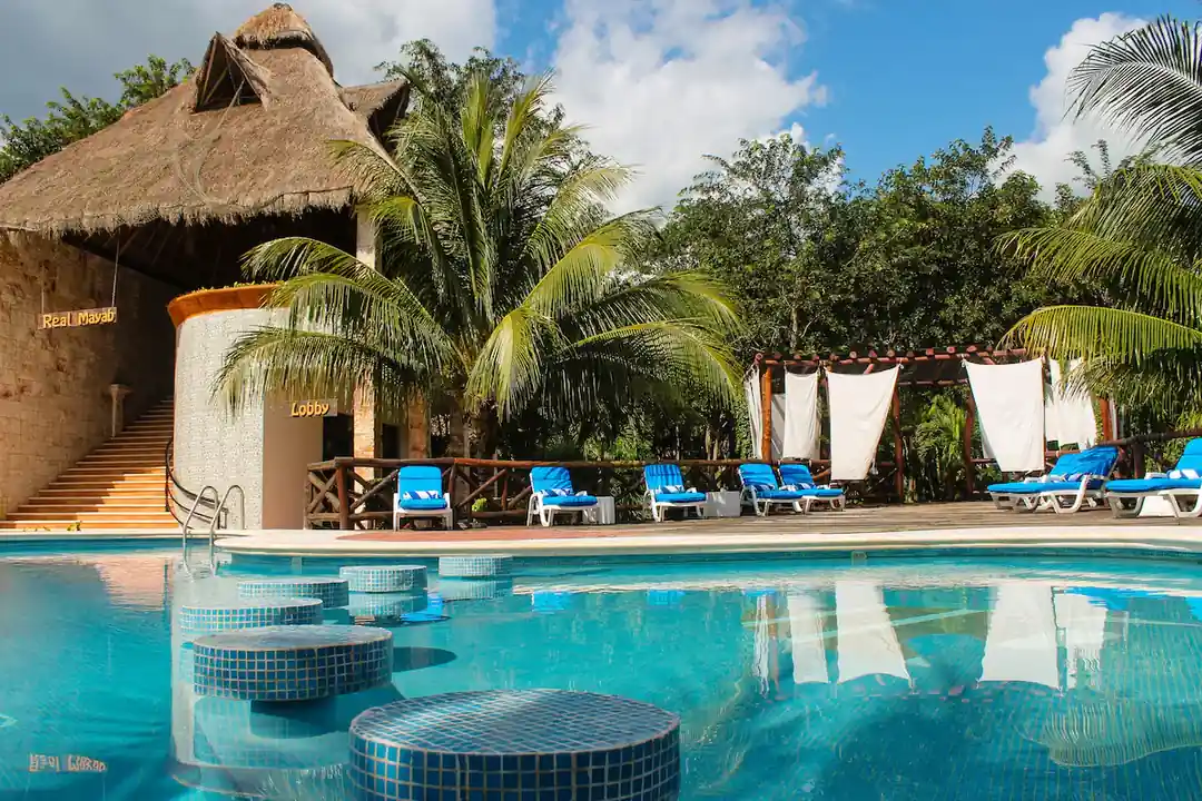Outdoor pool surrounded by palms