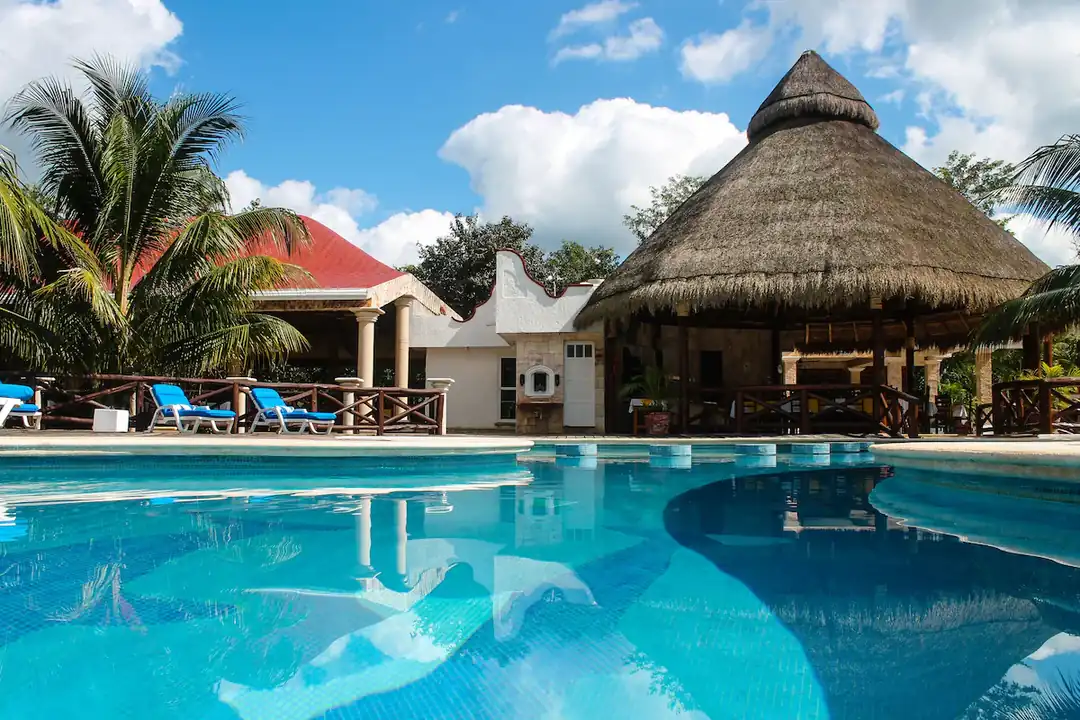 Real Mayab Hotel & Bungalows pool and tropical grounds